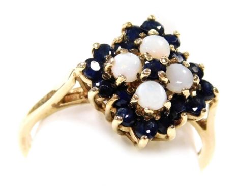 A 9ct gold opal and sapphire ring, with a lozenge shaped floral design, in a high claw basket setting, size O, 3.1g.