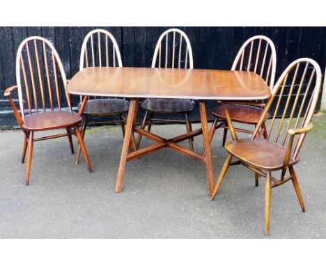 An Ercol dark elm dropleaf dining table, raised on fluted outswept supports, united by an X framed stretcher, 72cm high, 64cm