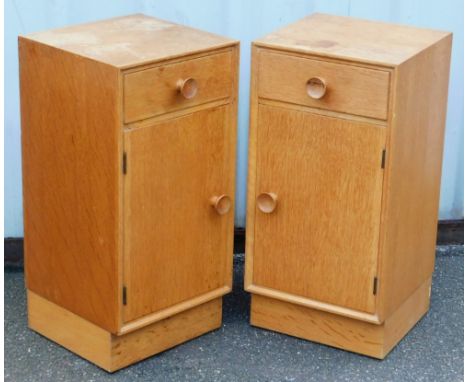 A pair of Meredew light oak bedside cupboards, each with a single drawer over a cupboard door, raised on a plinth base, 64.5c