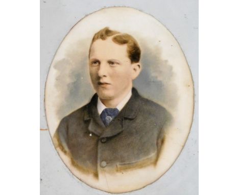 A Victorian overpainted photograph on porcelain, half-length portrait of a young man, in a gilt plaster oval frame, 29cm x 22