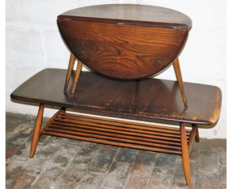 An Ercol dark elm coffee table, the oblong top raised on turned legs, united by a slatted under tier, 36cm high, 104cm wide, 