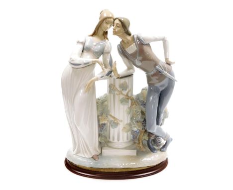 A Lladro porcelain figure group of Romeo and Juliet, modelled leaning against a central fluted column, printed marks, 42cm hi
