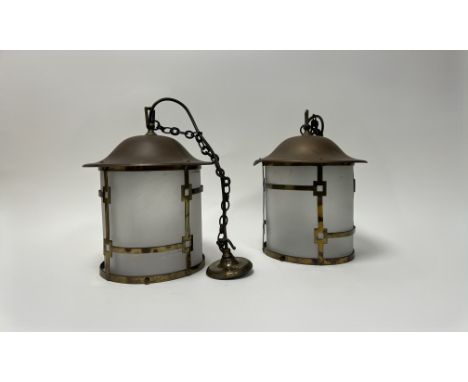 A pair of Arts and Crafts style pierced brass hanging lanterns with opaque glass shades (h.not incl hanging chain 30cm) with 