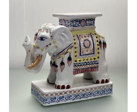 A decorative 1960's style chinoiserie ceramic elephant plant stand, raised on a square plinth, loss and repair made to trunk.
