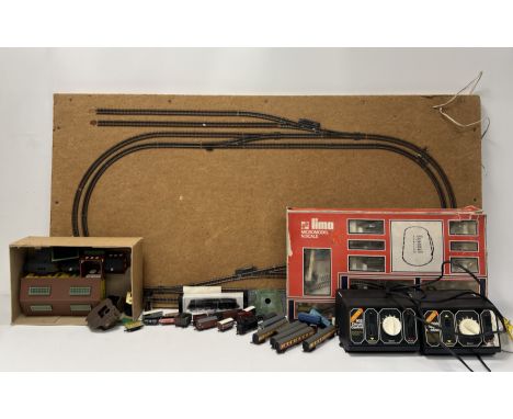 A large model railway train track mounted on a wooden board (l.122cm x h.62cm), together with an assorted collection of railw