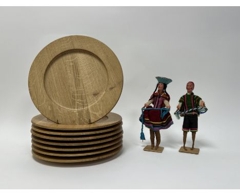 A collection of Danewood mid-century teak wooden plates (d. 27.5cm), together with a Peruvian folk art female and male wooden