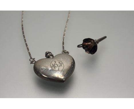 A modern London silver heart-shaped perfume flask with screw-down stopper: l. x 4cm on trace link chain and complete with sil