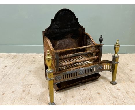 An Edwardian Adam revival wrought iron and steel mounted brass fire basket with arched top, complete with iron ash pan, missi