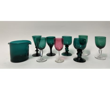A collection of coloured glass comprising, a pair of handblown green wine glasses with turned bases and beaded detail to stem