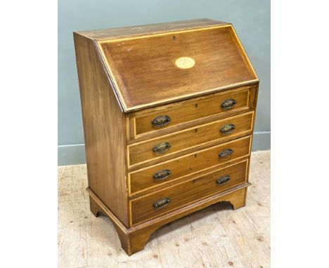 An Edwardian mahogany satinwood crossbanded bureau with fall front enclosing an arrangement of pigeonholes and drawers, above
