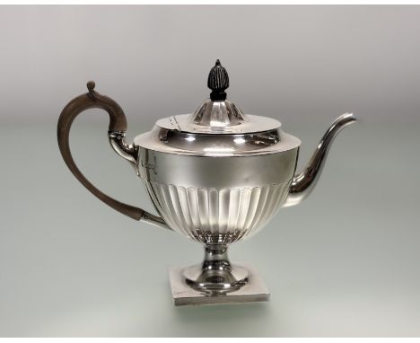 An Edwardian Sheffield silver Adam-style morning teapot of circular paneled design with wood knop and handle on square base S