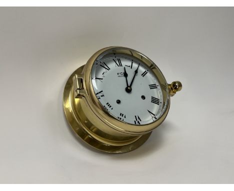An FCC Precision brass marine clock with quartz driven mechanism and hinge door design (a/f missing screws) (d. 19cm) 