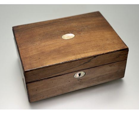 A 19thc rosewood veneered box with paper lined interior and inset mother of pearl oval panel to top and escutcheon: h. x 11cm