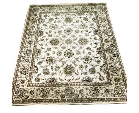 An Indian soft pile handmade Ziegler pattern carpet, the central panel with raidiating lotus flowers and scrolling leaves enc