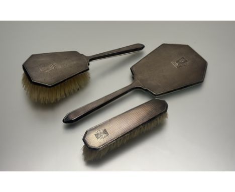 A Birmingham silver Art Deco three-piece dressing table set with engine-turned decoration and initials: C. W. and original br