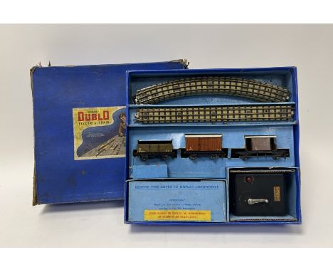 A boxed Hornby Dublo goods train set comprising, a locomotive and three wagons, together with a controller, and curved and st