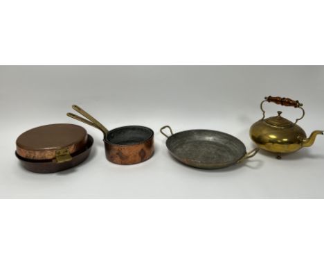 A collection of copper pots comprising, a copper saucepan with brass handle to side (d. 17cm), a similar smaller copper sauce