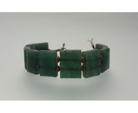 A Chinese spinach green jadeite graduated panel bracelet with gilt metal wire spacers - one section detached and ring and t-b