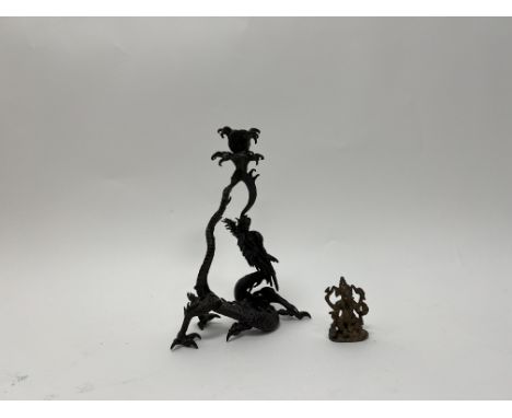A Japanese bronze candlestick cast as the wrythen dragon above waves breathing fire (h. 22cm), together with a small brass st