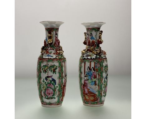 A pair of late 20thc Chinese familie rose vases, with panel scenes enclosed within floral borders to body and neck with gilt 