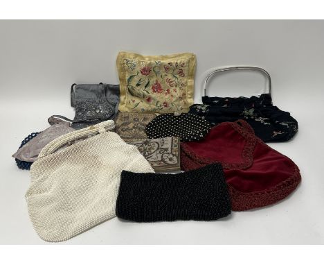 A collection of ladies vintage purses and handbags comprising, a black beaded purse with leaf detail (l. 23cm), a larger 1950
