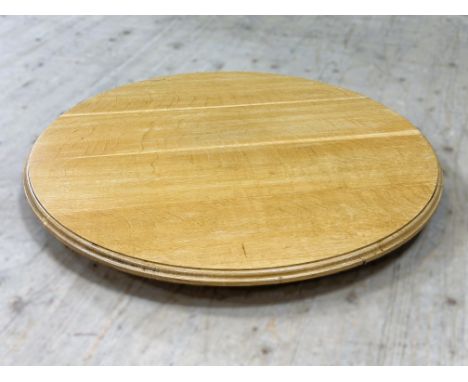 An Edwardian light oak large revolving table stand (d.81cm)