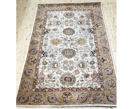 An Indian Ziegler pattern hand woven and backed rug with lotus flower and leaf scrolling centre panel enclosed within a simil