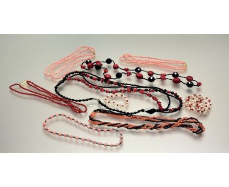 A collection of pink and dyed red coral bead necklaces to include, four two-stand choker style necklaces: l. x 20cm, a pink c