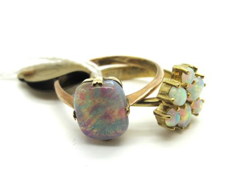 A 9ct Gold Opal Set Cluster Dress Ring, abstract claw set with three oval and three circular cabochon opals; together with a 