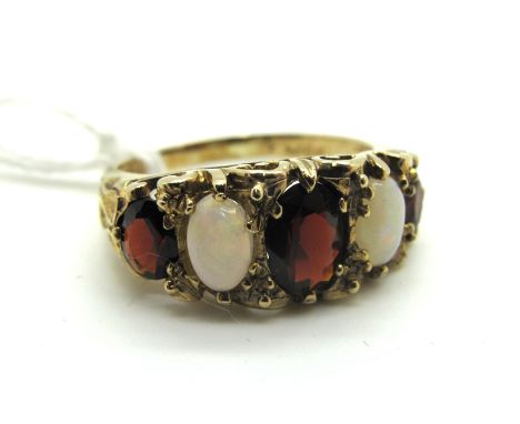 A 9ct Gold Opal and Garnet Five Stone Ring, graduated set in Victorian style openwork scroll mount.