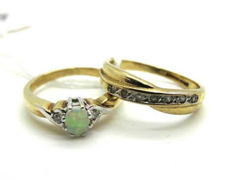 A Modern 9ct Gold Opal and Diamond Set Three Stone Ring, oval claw set to the centre; together with a 9ct gold inset band rin