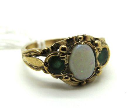 A 9ct Gold Opal and Emerald Three Stone Ring, oval cabochon set to the centre, between pierced shoulders.