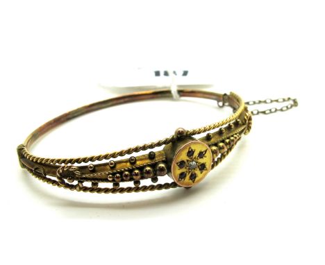 A Late XIX/Early XX Century Hinged Bangle, stone set to the centre of flowerhead design, between openwork bead and ropetwist 