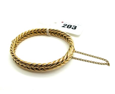 A Two Row Ropetwist Bangle, of uniform design, hinged to snap clasp, stamped "15".