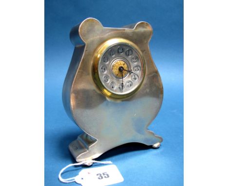 A Hallmarked Silver Framed Mantel Clock, (marks rubbed) the textured dial with Arabic numerals, within shaped case, raised on