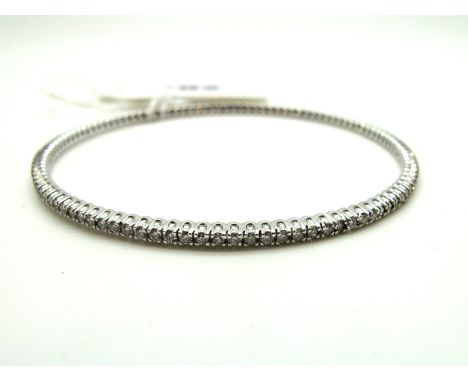 A Modern 18ct White Gold Diamond Set Bangle, of uniform design, claw set throughout with uniform brilliant cut stones, approx