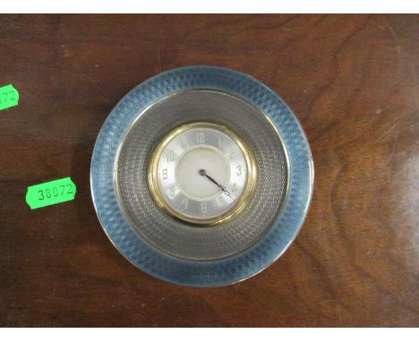 A silver mounted circular travelling clock, with enamelled band and engine turned band, having an easel support, diameter 4.2