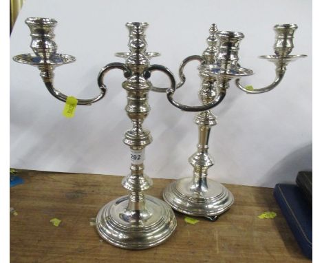 A pair of silver candelabra, with two branches, on a knopped stem, London 1958