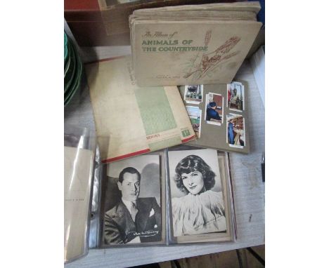 An album of portrait postcards of stars from the day, to include Greta Garbo, together with various cigarette albums
