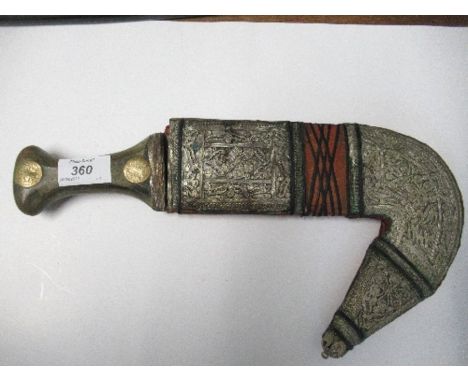 An Arabic Jambiya dagger, with horn handle inset with coins, and white metal scabbard