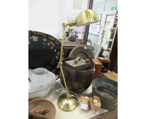 A brass coloured angle poise desk lamp