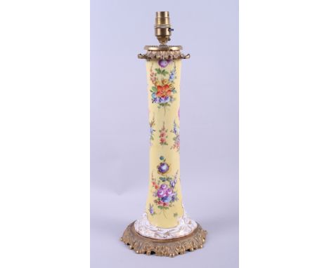 A late 19th century Continental porcelain table lamp, decorated floral sprays on a yellow ground, with gilt brass fittings, 1