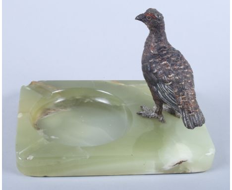 An Austrian cold painted bronze model of a red grouse, mounted on an onyx ashtray base The overall dimensions are 6 1/2" x 5"
