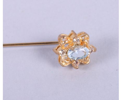A gold and citrine bar brooch, a gold and topaz bar brooch and a gilt metal stick pin, set aqua coloured stones 