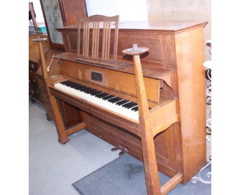 A Bechstein upright piano, in Arts & Crafts oak case designed by Walter Crane, with strap hinges and candle sconces to either