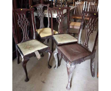 A set of four mahogany chairs of Chippendale design with pierced splat drop-in seats 