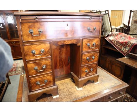 A mahogany kneehole desk of early Georgian design, fitted slide over seven drawers, on bracket feet, 31" wide 