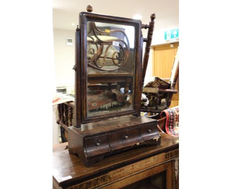 A George III mahogany swing frame toilet mirror, on plateau base, fitted three shaped front drawers, on bracket feet 