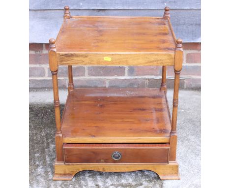 A yew wood two-tier lamp table, fitted one drawer, on bracket supports, 18" wide 