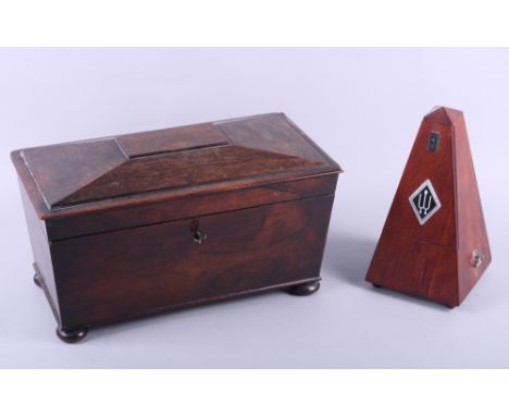 A Regency rosewood sarcophagus tea caddy, on squat bun feet, 13" long, together with a modern metronome 